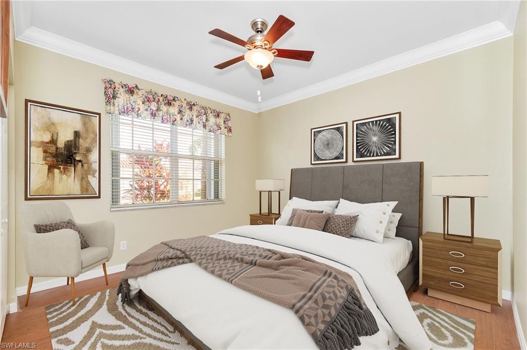 9381 Springview Loop Estero, FL 33928 - Photo 15 of 35 a bedroom with a bed and a chandelier