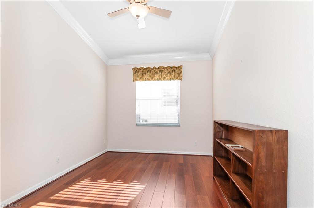 9381 Springview Loop Estero, FL 33928 - Photo 17 of 35 a view of an empty room with a window and wooden floor