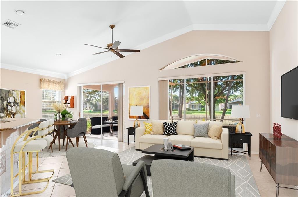 9381 Springview Loop Estero, FL 33928 - Photo 10 of 35 a living room with furniture large windows and a flat screen tv