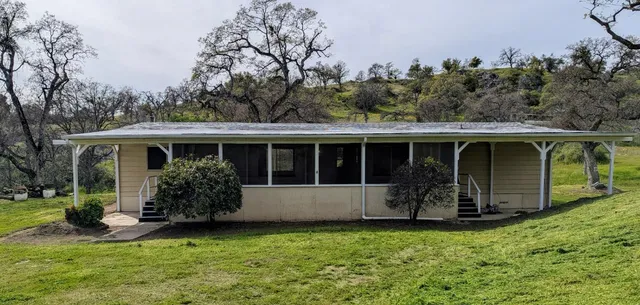 a front view of house with yard and porch