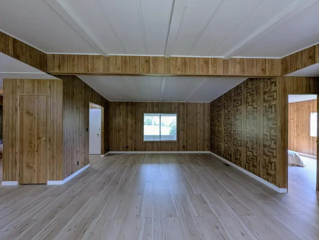 an empty room with wooden floor