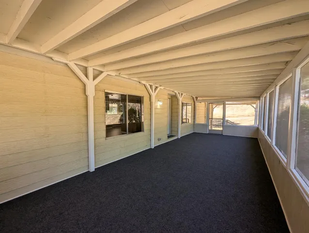 a view of hallway with wooden floor