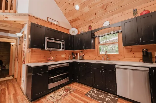 a kitchen with stainless steel appliances granite countertop a sink and stove top oven