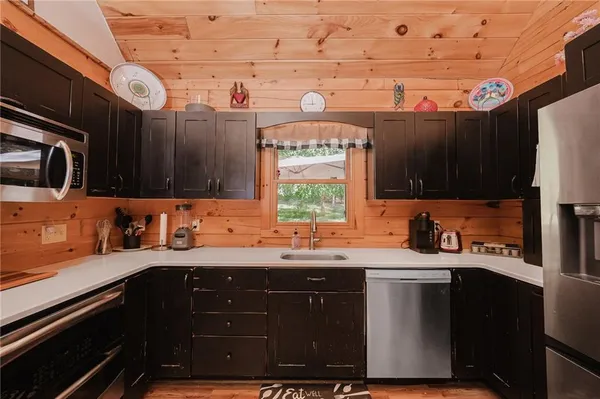 a kitchen with stainless steel appliances a sink stove and cabinets