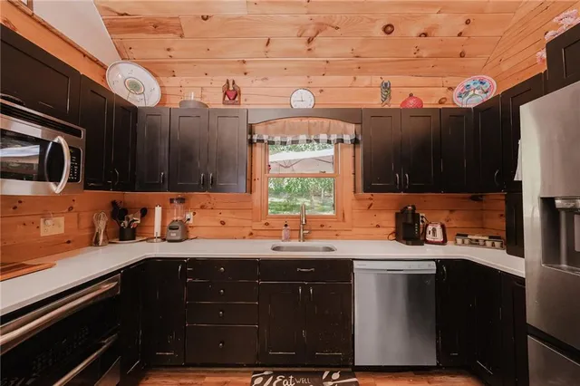a kitchen with stainless steel appliances a sink stove and cabinets
