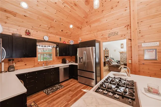 a kitchen with stainless steel appliances a stove a sink and a refrigerator