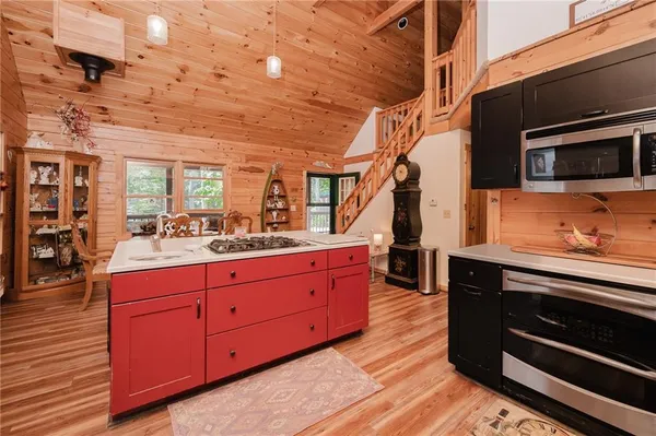 a kitchen with stainless steel appliances kitchen island wooden cabinets and granite counter tops