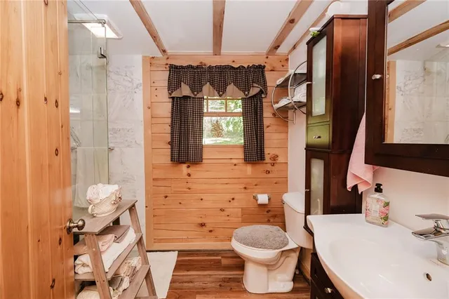 a bathroom with a sink toilet and shower
