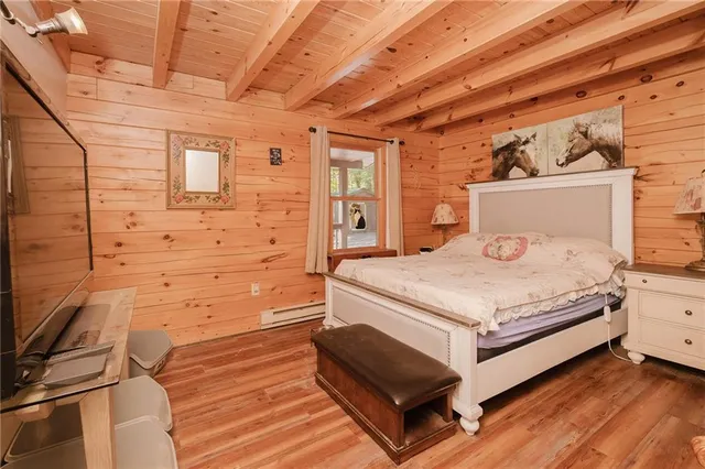 a bed sitting in a spacious bedroom next to a window