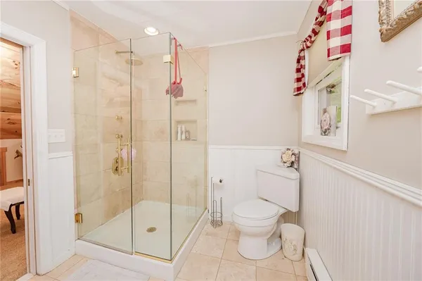 a bathroom with a shower toilet and sink