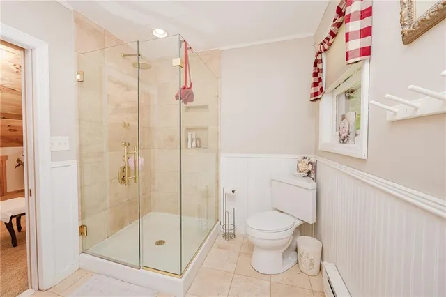 a bathroom with a shower toilet and sink