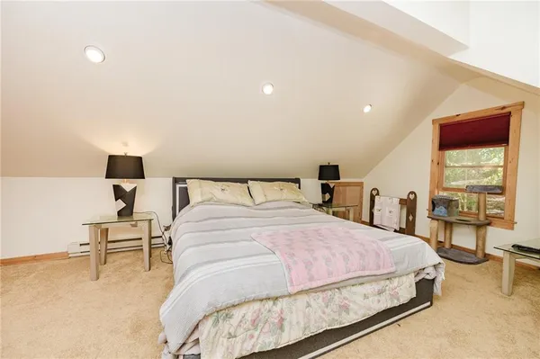 a bedroom with a bed and lamp with table