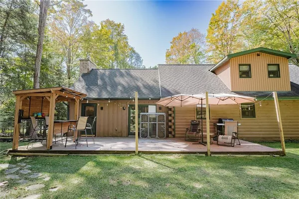 a view of a house with a yard and sitting area