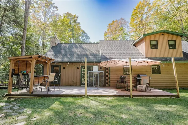 a view of a house with a yard and sitting area