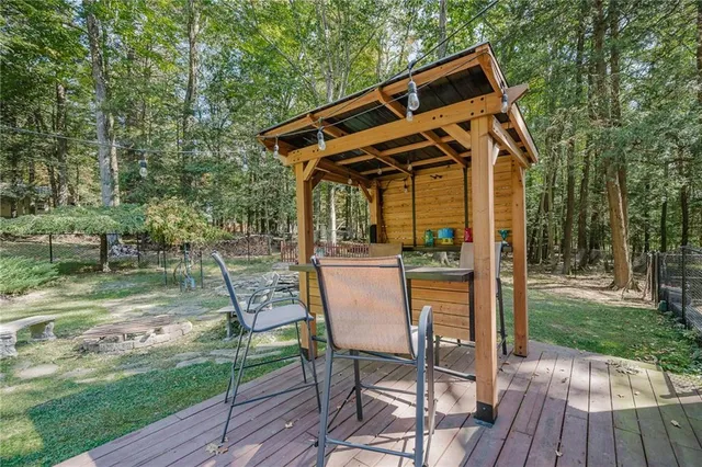 a view of a chair and table on the wooden deck