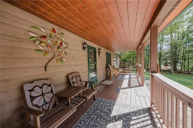 a view of a patio with table and chairs and wooden floor