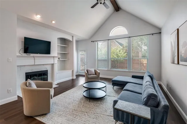 a living room with furniture a fireplace and a flat screen tv