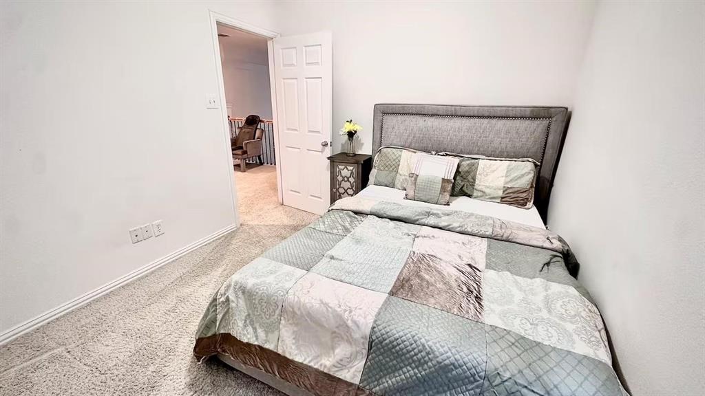 1237 Tioga Drive Irving, TX 75063 - Photo 11 of 15 a large bed sitting in a bedroom next to a lamp