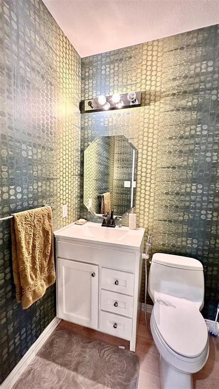 1237 Tioga Drive Irving, TX 75063 - Photo 15 of 15 a bathroom with a toilet sink and mirror
