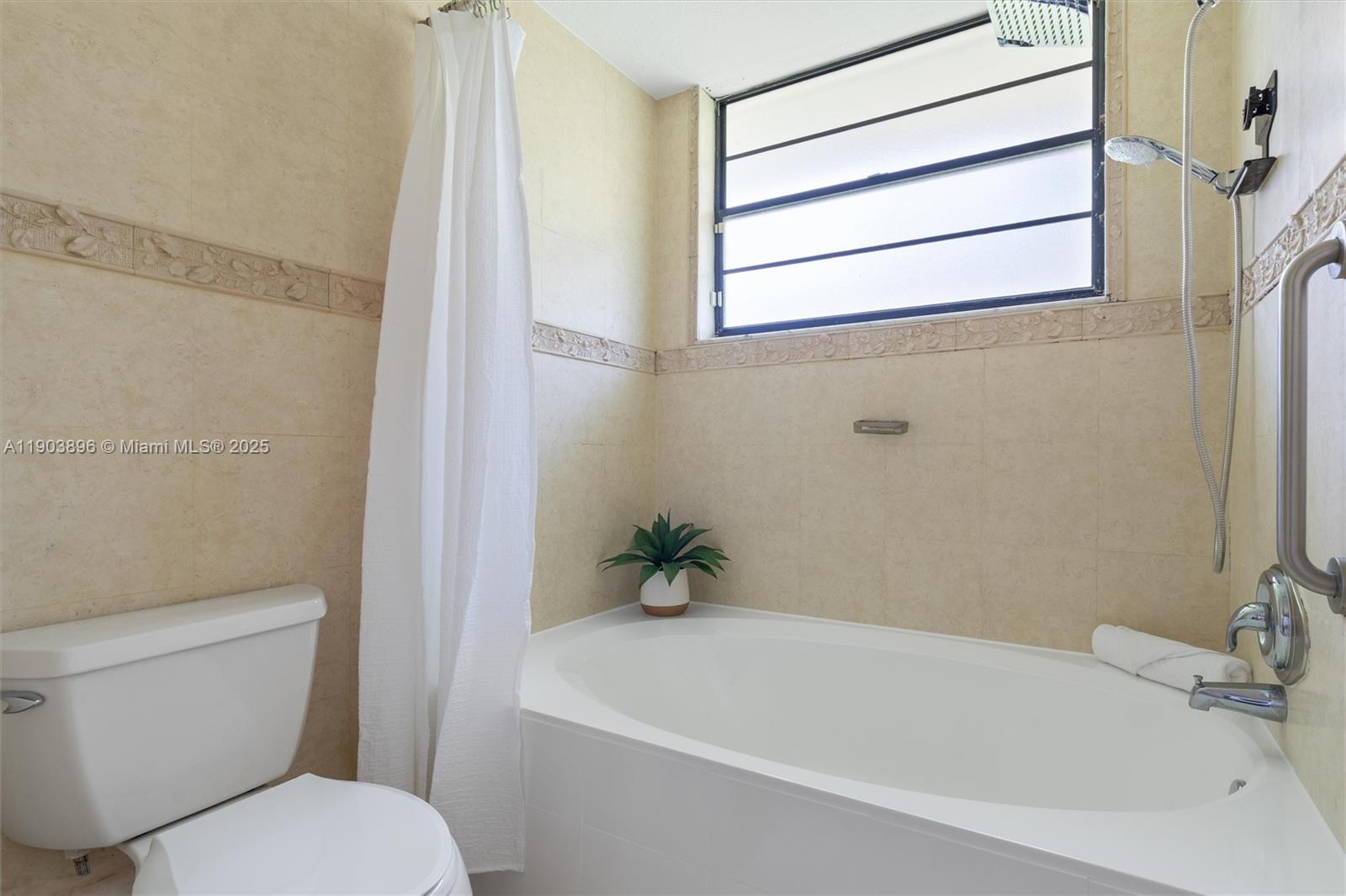 8001 Royal Palm Circle, Unit 57 Tamarac, FL 33321 - Photo 11 of 16 a white bath tub sitting next to a white toilet