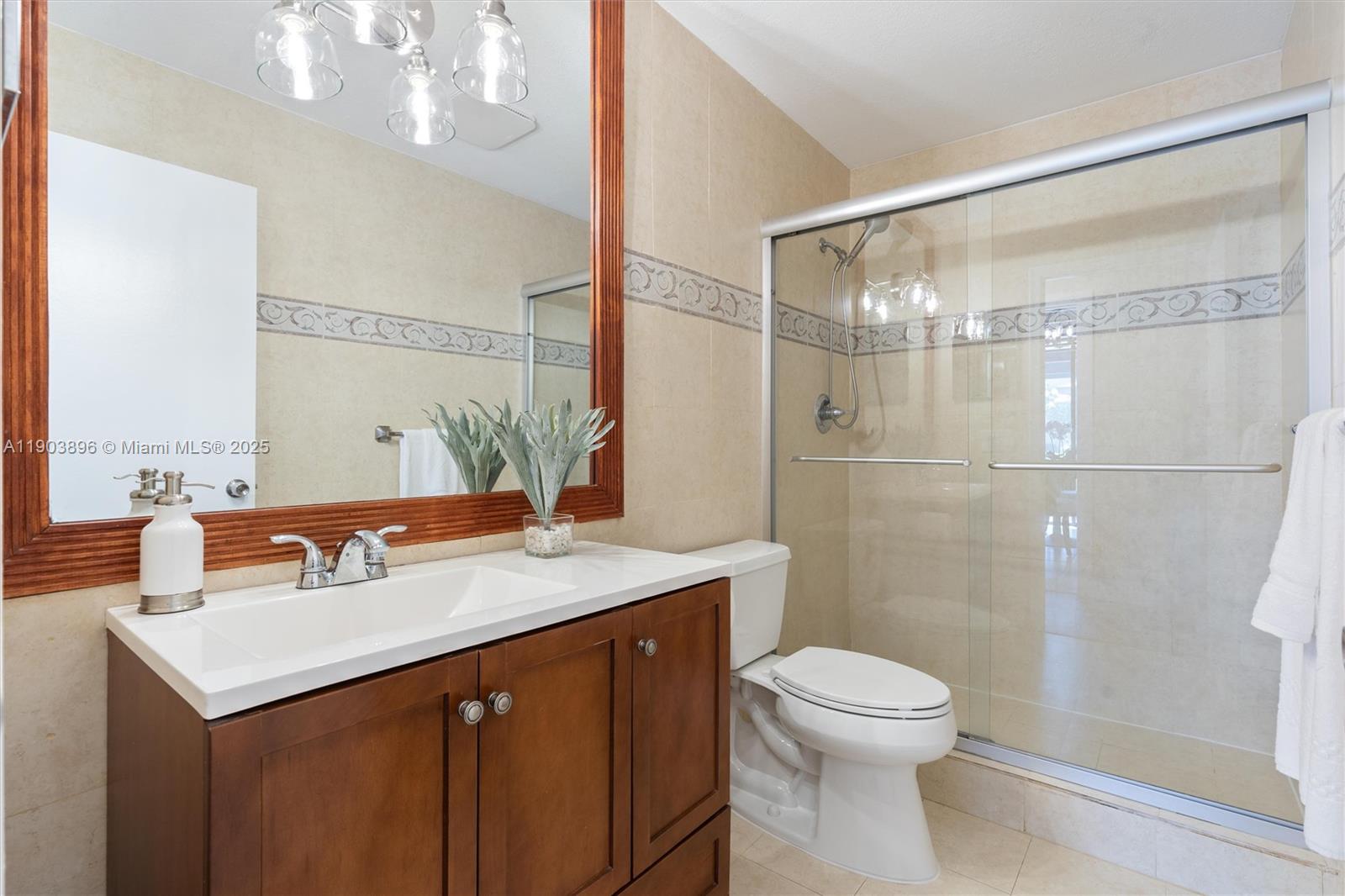 8001 Royal Palm Circle, Unit 57 Tamarac, FL 33321 - Photo 13 of 16 a bathroom with a sink a toilet and shower