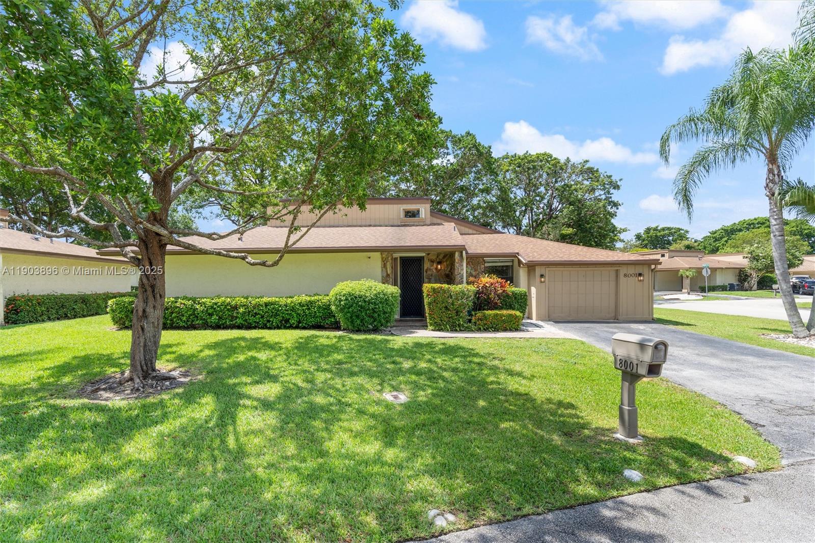 8001 Royal Palm Circle, Unit 57 Tamarac, FL 33321 - Photo 2 of 16 a front view of a house with garden