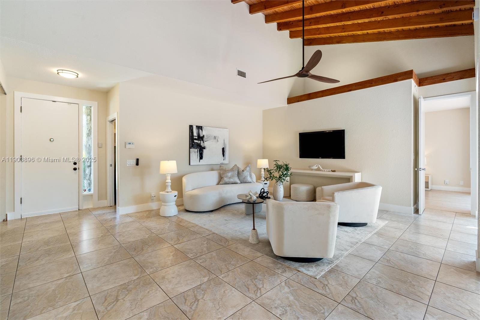 8001 Royal Palm Circle, Unit 57 Tamarac, FL 33321 - Photo 5 of 16 a living room with furniture and a flat screen tv