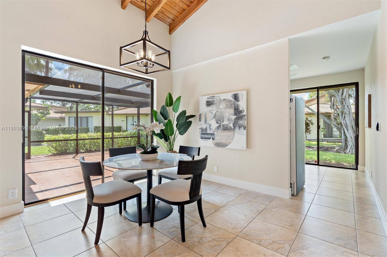 8001 Royal Palm Circle, Unit 57 Tamarac, FL 33321 - Photo 6 of 16 a dining room with furniture and a floor to ceiling window