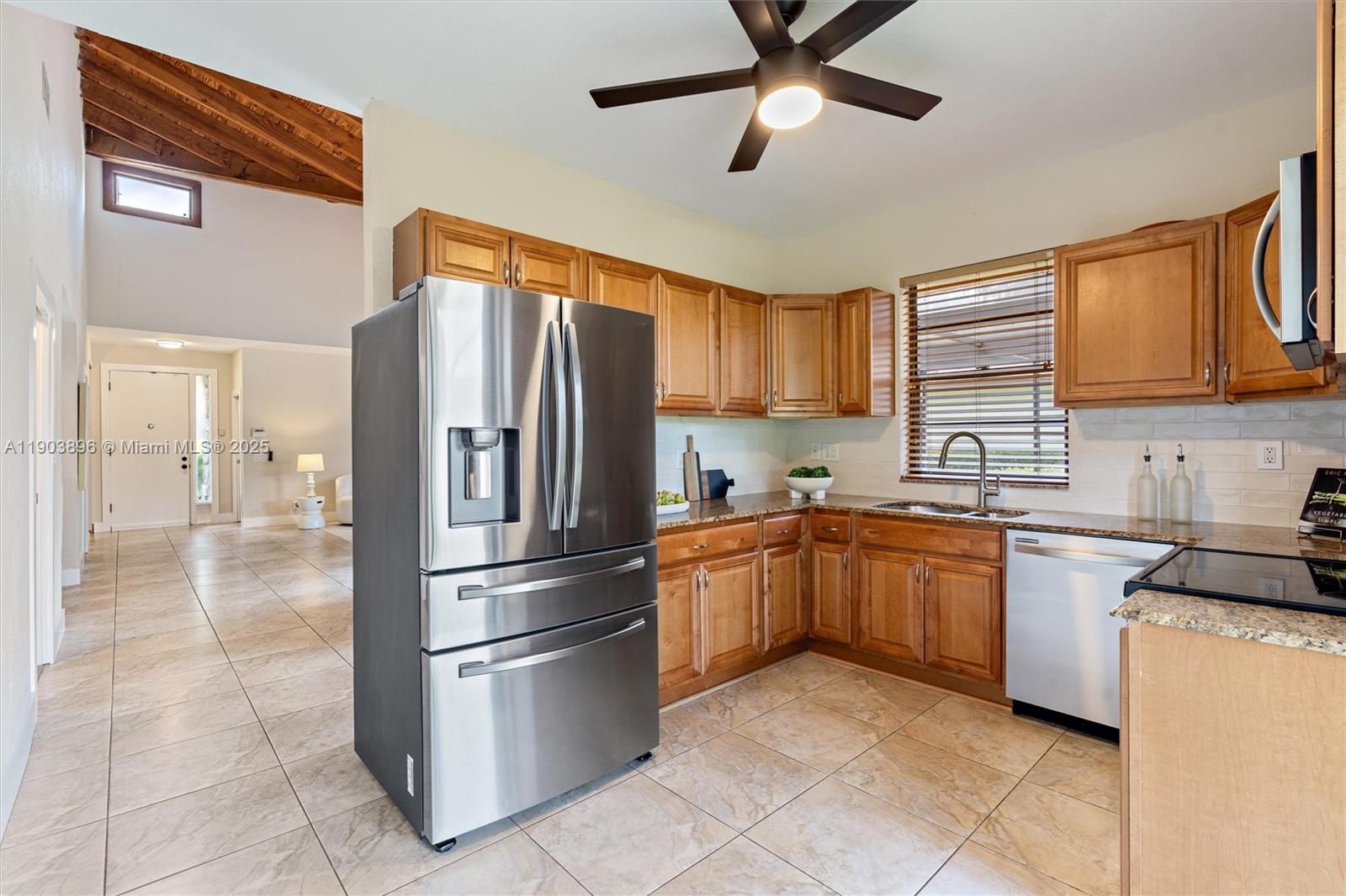 8001 Royal Palm Circle, Unit 57 Tamarac, FL 33321 - Photo 7 of 16 a kitchen with stainless steel appliances granite countertop a refrigerator oven a sink dishwasher and a refrigerator