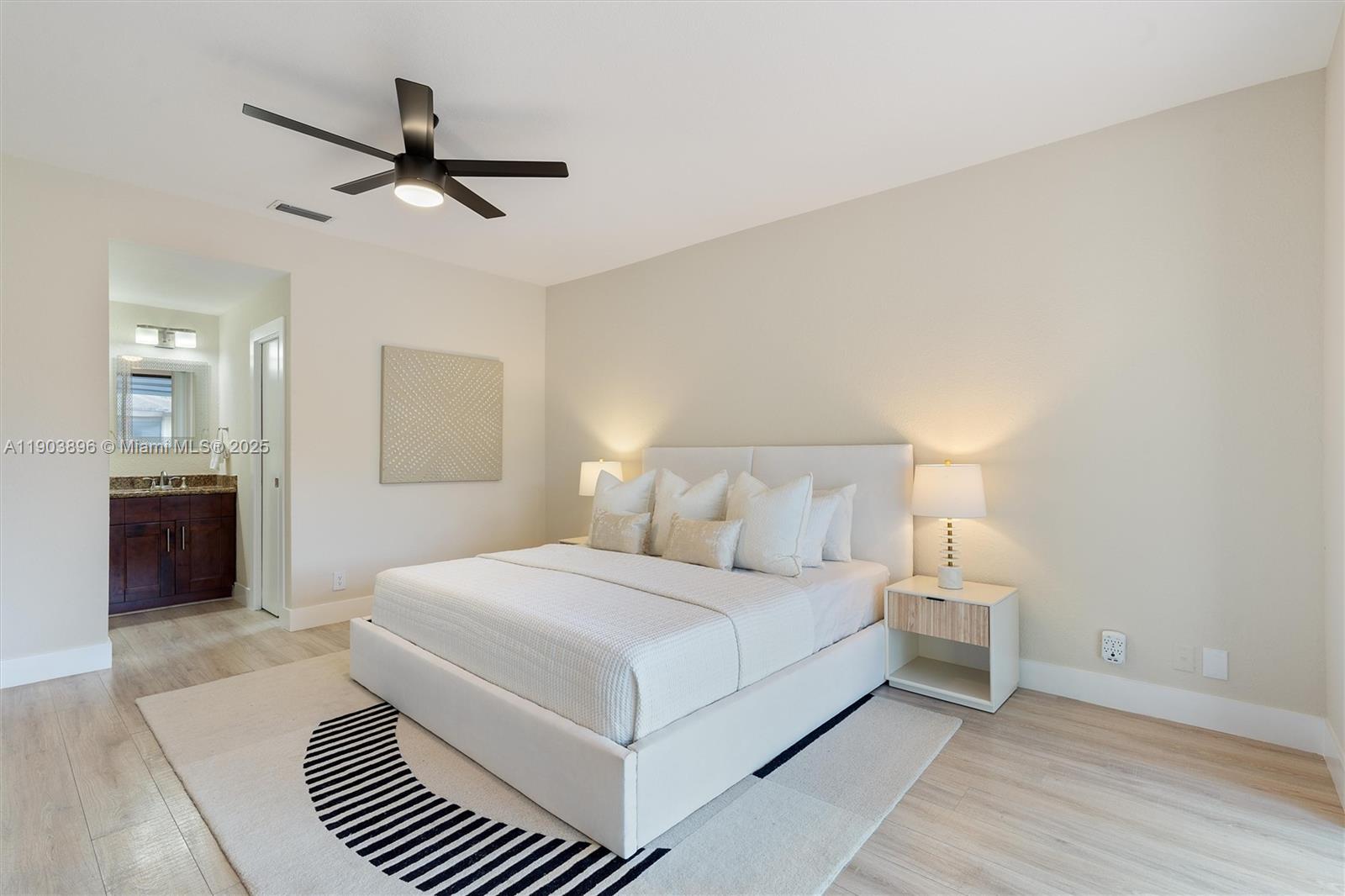 8001 Royal Palm Circle, Unit 57 Tamarac, FL 33321 - Photo 8 of 16 a bedroom with a large bed and a chandelier