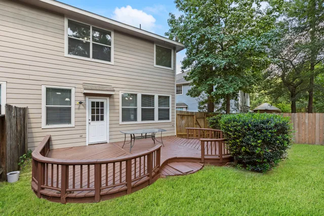 a view of a house with a deck and a garden