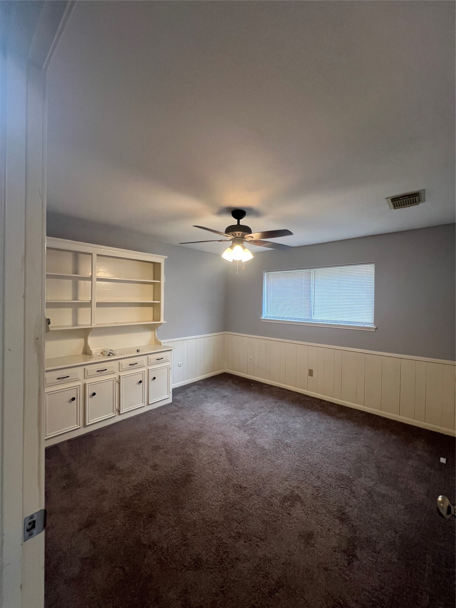 2015 Hamlin Valley Drive Houston, TX 77090 - Photo 16 of 31 an empty room with windows and fan