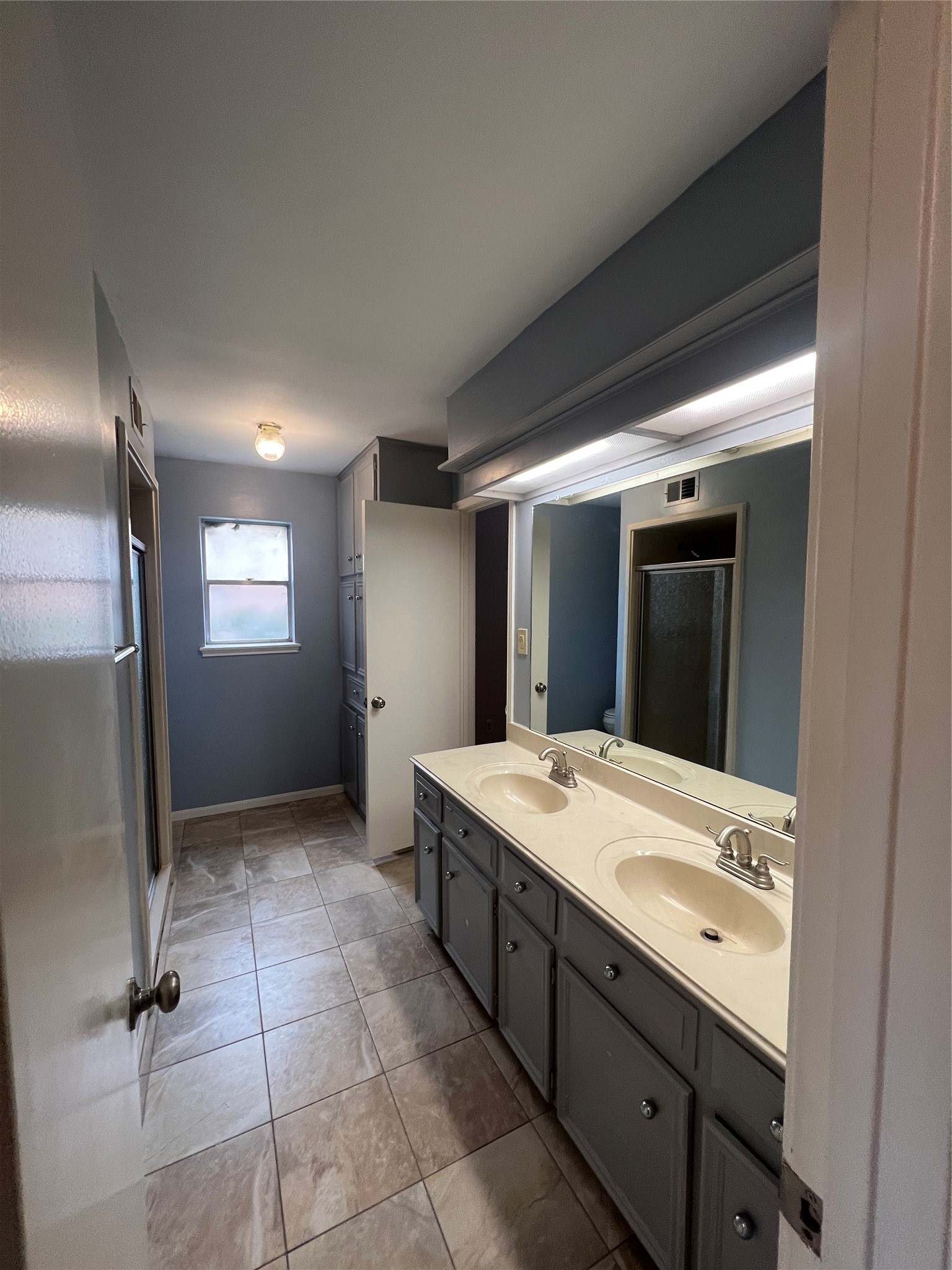 2015 Hamlin Valley Drive Houston, TX 77090 - Photo 18 of 31 a bathroom with a sink a vanity and mirror