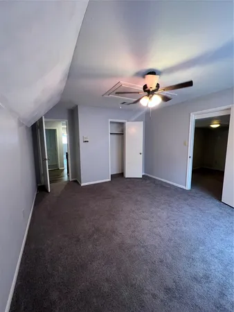 a view of a livingroom with a ceiling fan and window