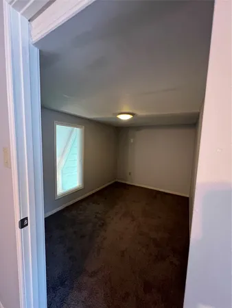 a view of an empty room and a window