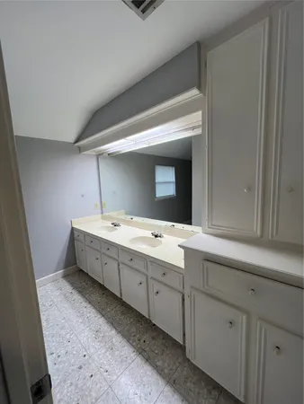 a bathroom with a tub sink and mirror