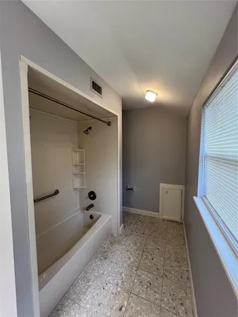 a bathroom with a bathtub and shower