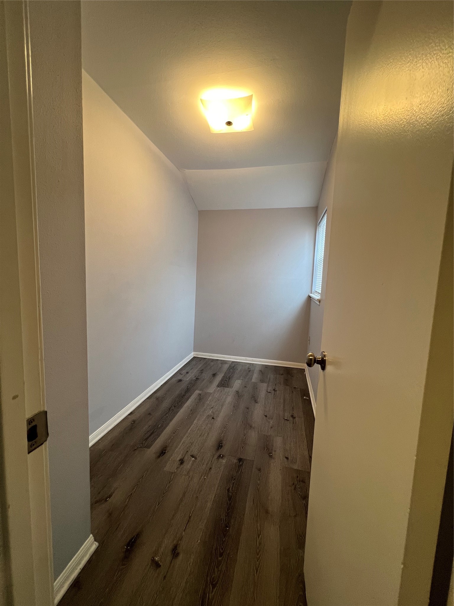 2015 Hamlin Valley Drive Houston, TX 77090 - Photo 25 of 31 an empty room with wooden floor and windows