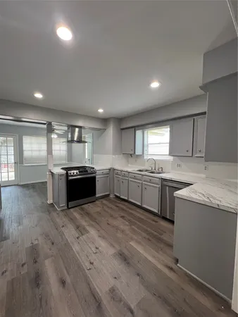 a kitchen with stainless steel appliances granite countertop a stove and a sink