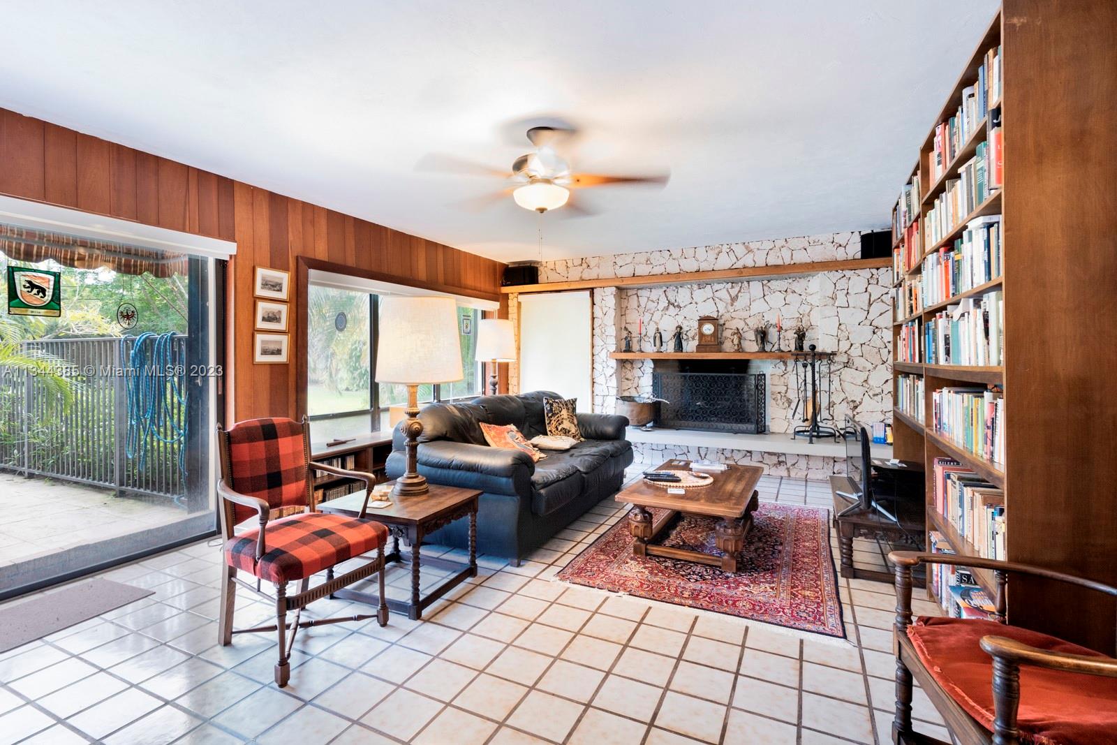 12555 Moss Ranch Road Pinecrest, FL 33156 - Photo 15 of 26 a living room with furniture fireplace and flat screen tv