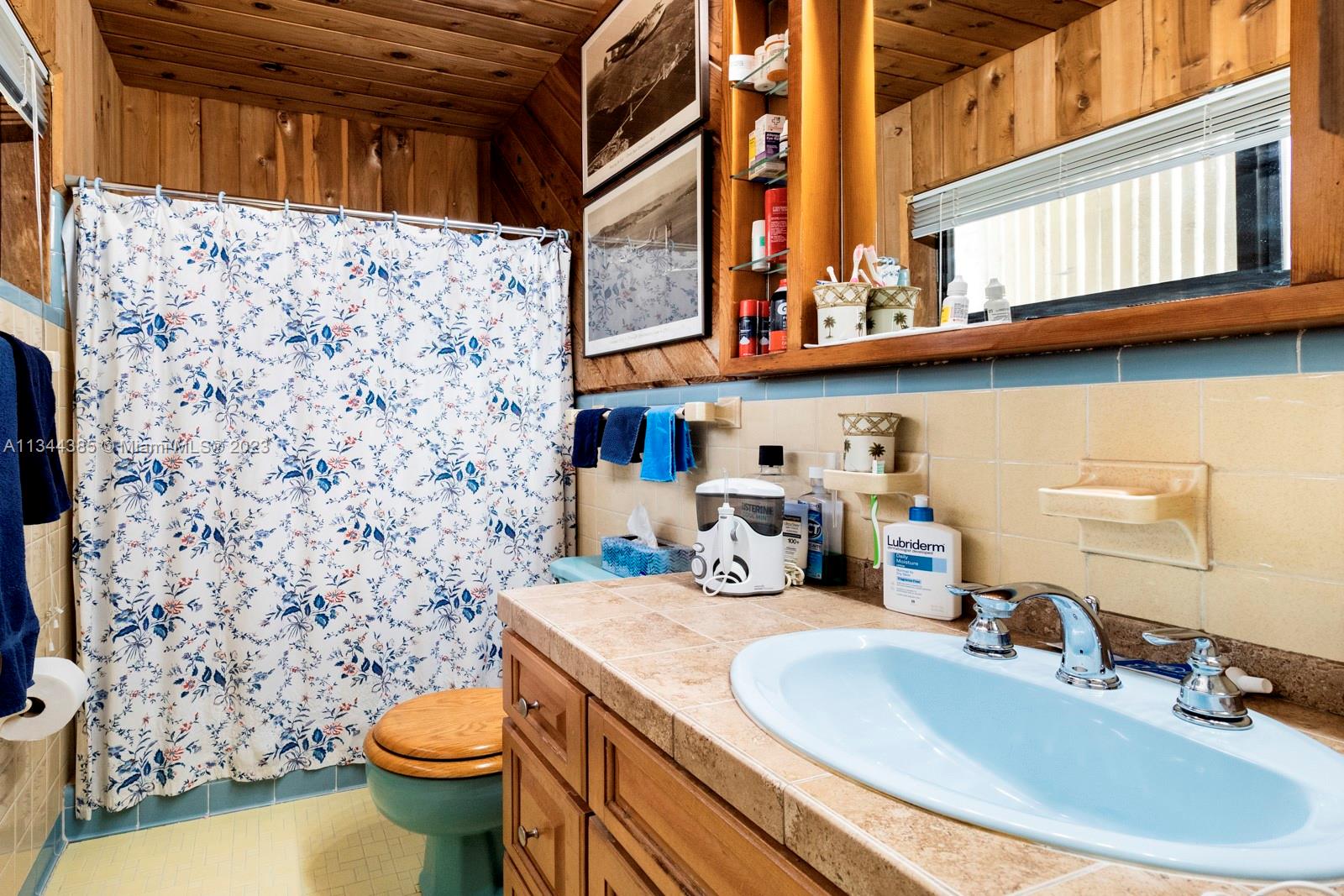 12555 Moss Ranch Road Pinecrest, FL 33156 - Photo 19 of 26 a bathroom with a sink toilet and shower