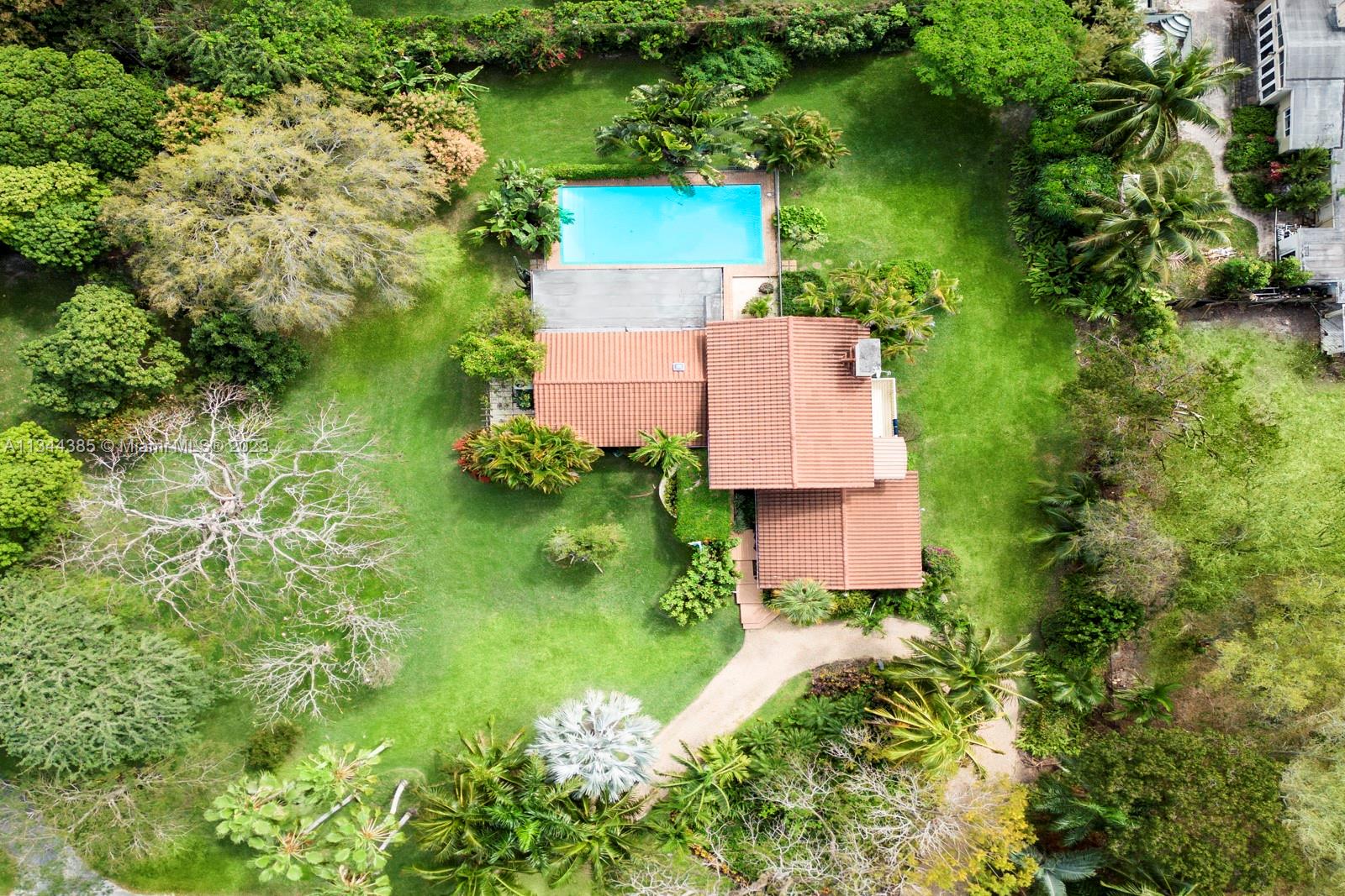 12555 Moss Ranch Road Pinecrest, FL 33156 - Photo 2 of 26 an aerial view of a house with a yard