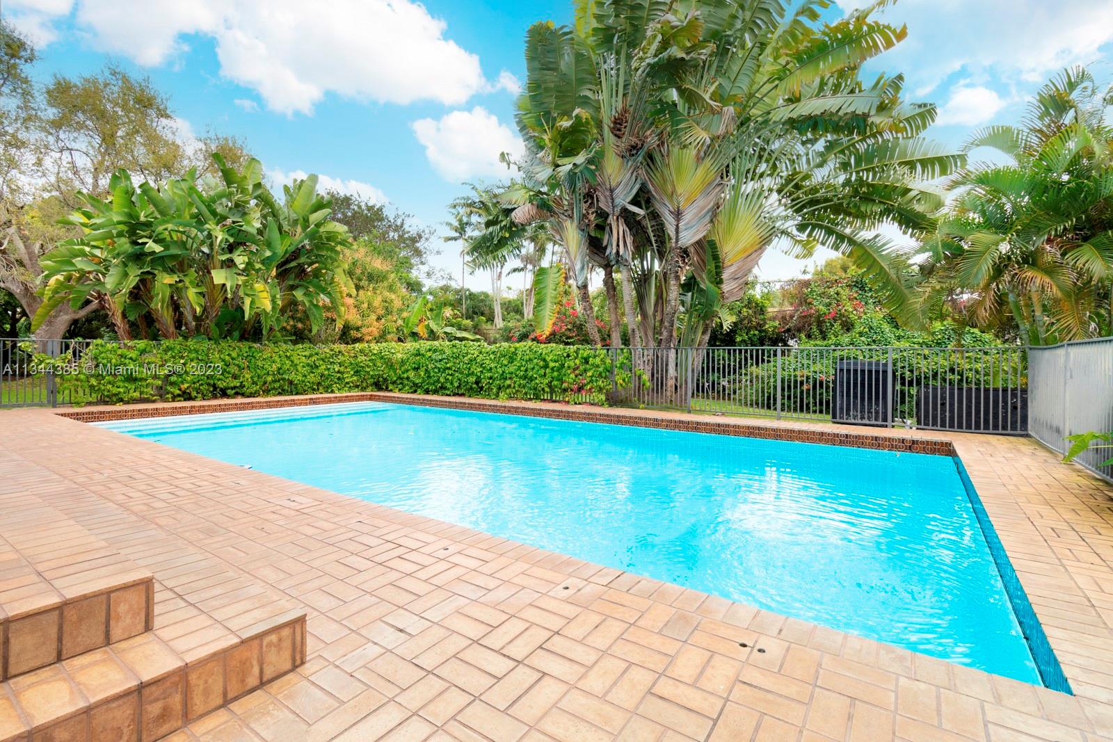 12555 Moss Ranch Road Pinecrest, FL 33156 - Photo 21 of 26 a view of swimming pool with a yard