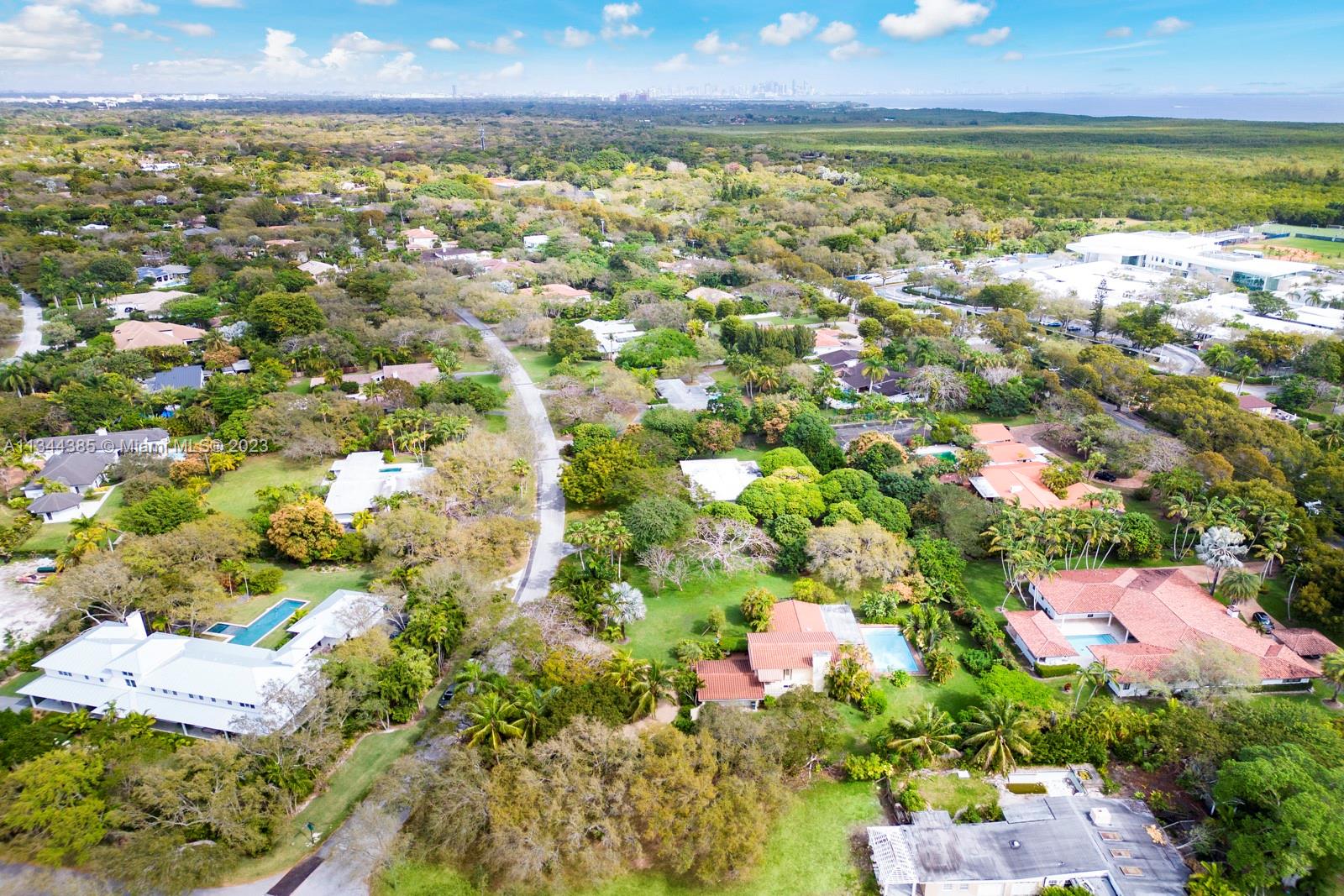 12555 Moss Ranch Road Pinecrest, FL 33156 - Photo 26 of 26 an aerial view of residential houses with outdoor space and trees