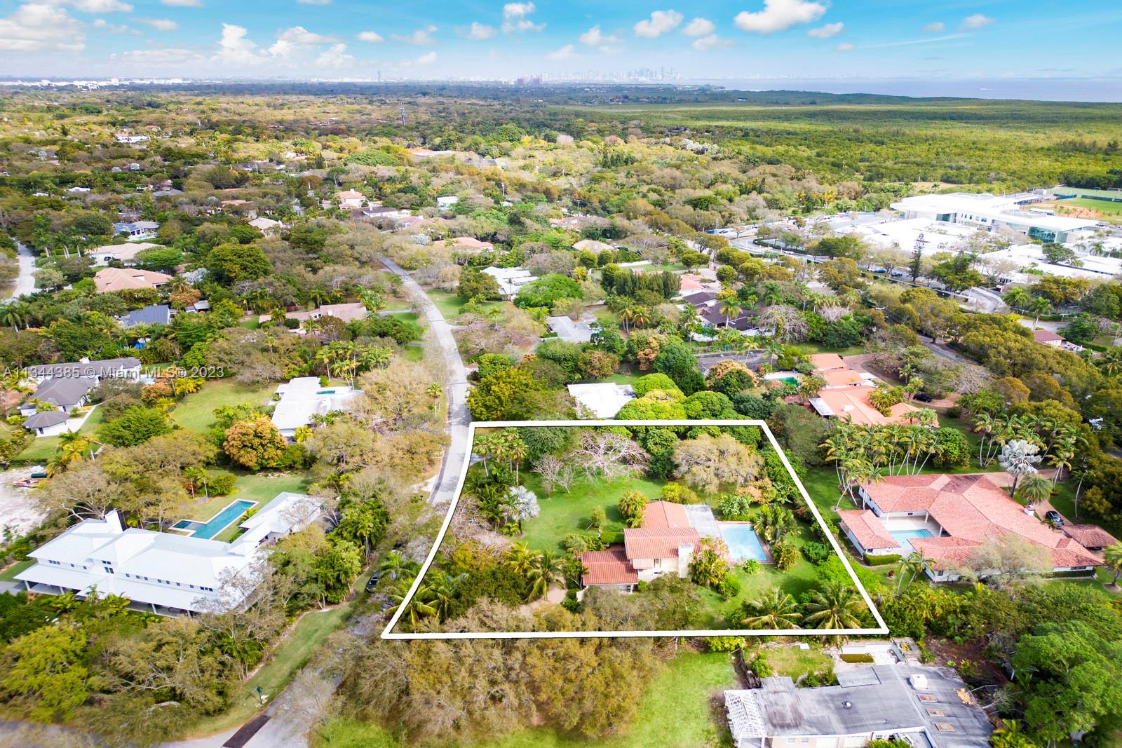 12555 Moss Ranch Road Pinecrest, FL 33156 - Photo 4 of 26 an aerial view of residential houses with outdoor space and swimming pool