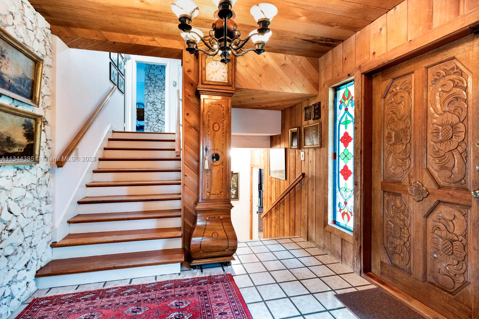 12555 Moss Ranch Road Pinecrest, FL 33156 - Photo 9 of 26 a view of entryway with stairs and wooden floor