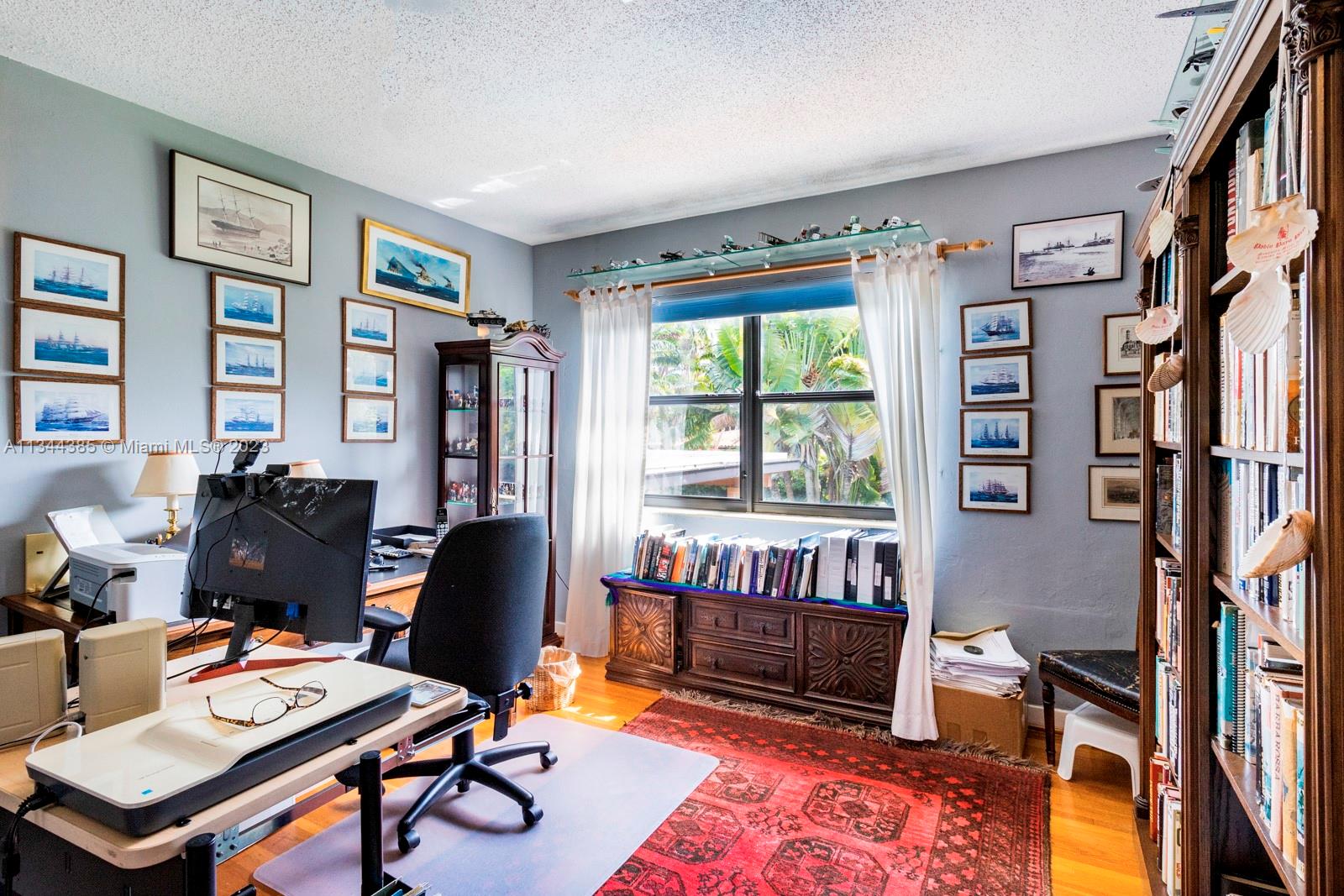12555 Moss Ranch Road Pinecrest, FL 33156 - Photo 10 of 26 a view of a workspace with furniture and a window