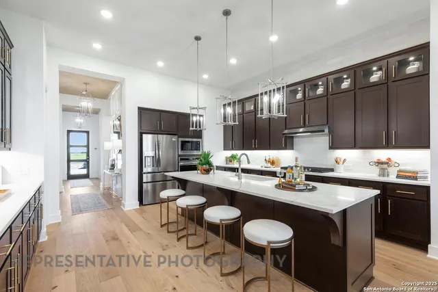 a kitchen with a sink stainless steel appliances and cabinets