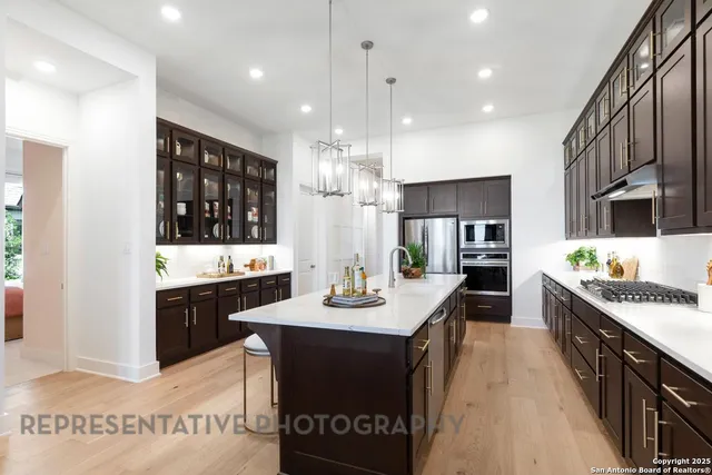 a kitchen with granite countertop a sink stove and cabinets