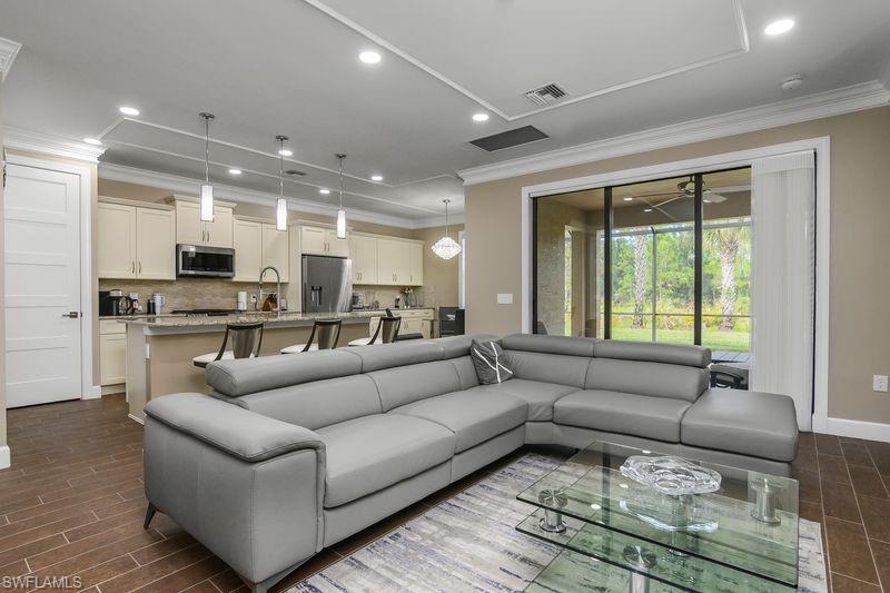 16309 Winfield Lane Naples, FL 34110 - Photo 13 of 36 a living room with furniture and a large window